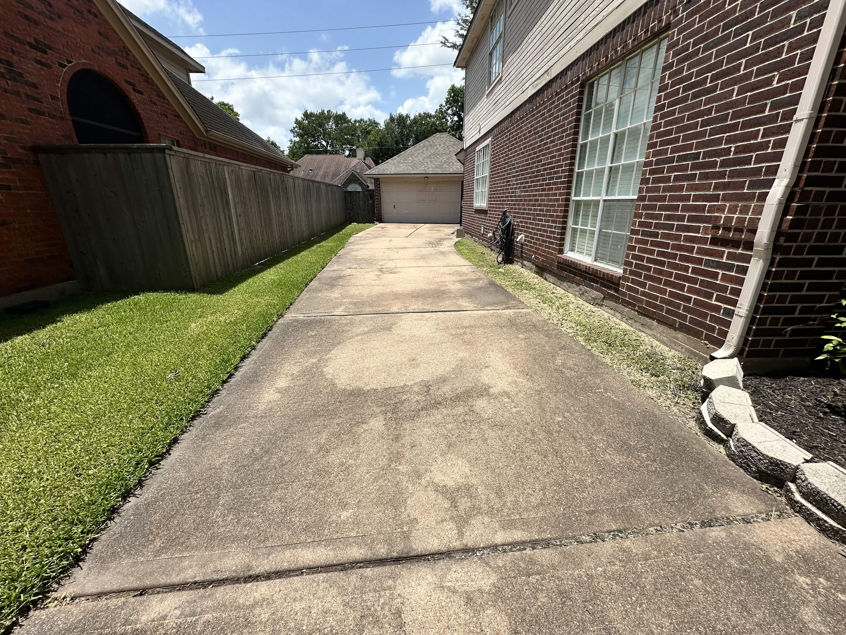 Driveway before pressure washing — stained concrete in Cypress TX