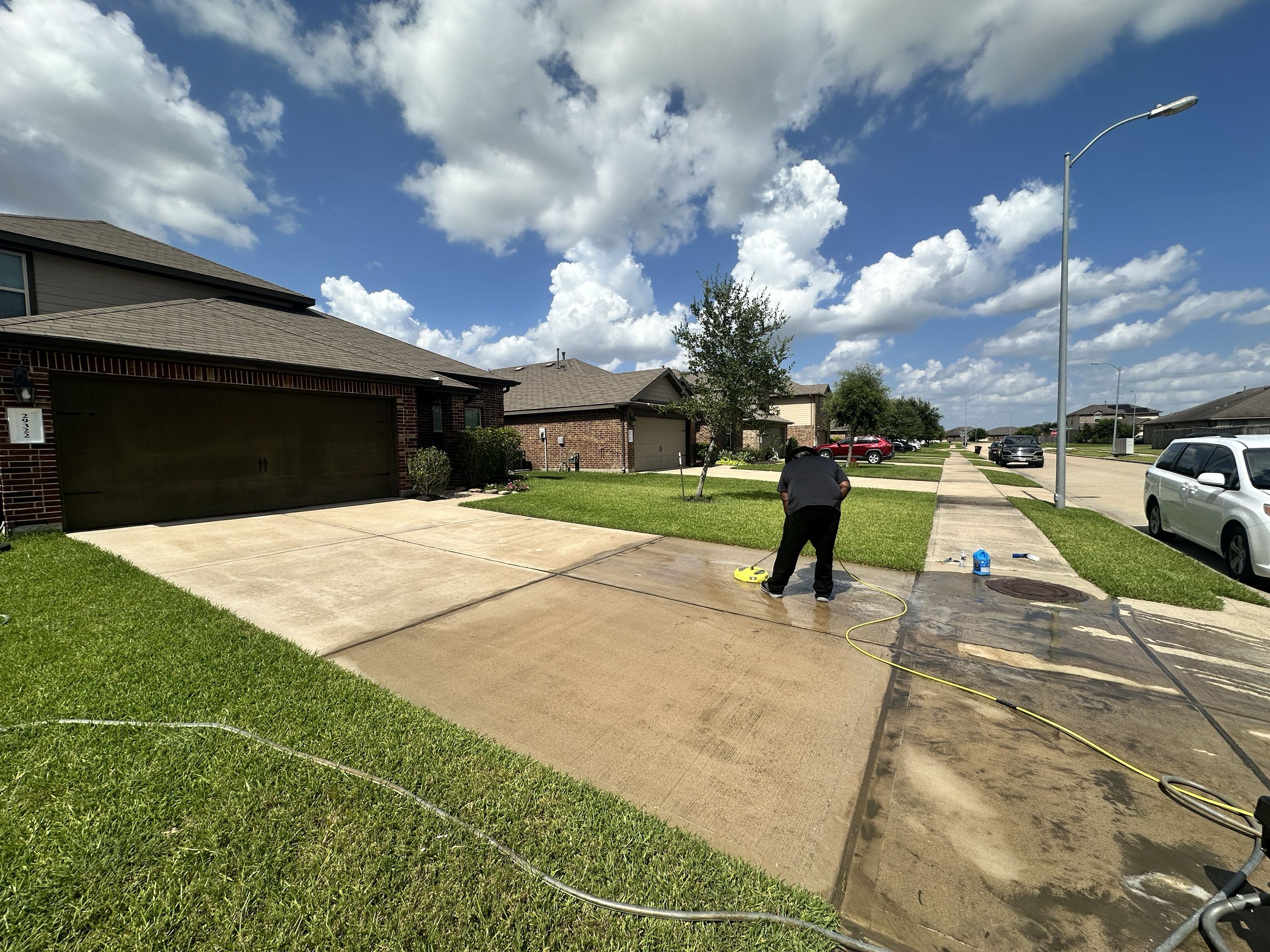 Northrock Exteriors technician eco-conscious pressure washing in a Cypress TX neighborhood